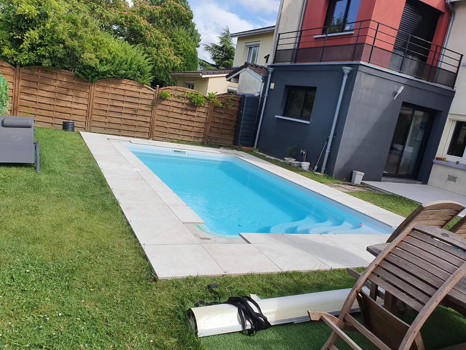 Piscine dans un jardin, pelouse et marjelle autour de la piscine